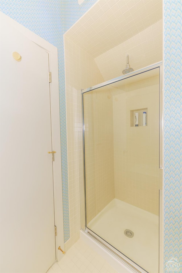 bathroom featuring tile patterned flooring and a shower with shower door