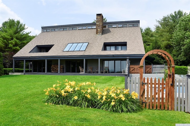 rear view of house with a yard