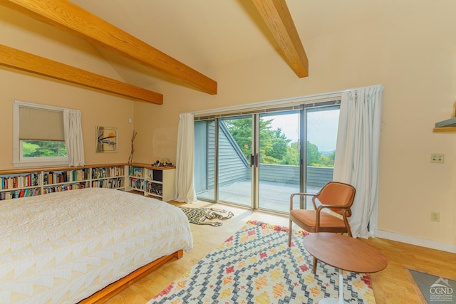 bedroom with beamed ceiling and access to exterior