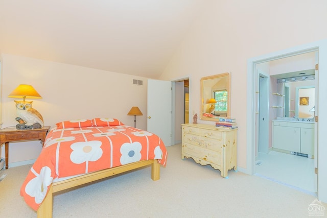 bedroom featuring carpet, connected bathroom, vaulted ceiling, and sink