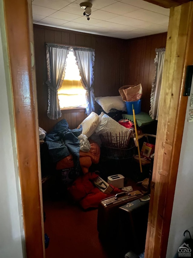 bedroom with wood walls