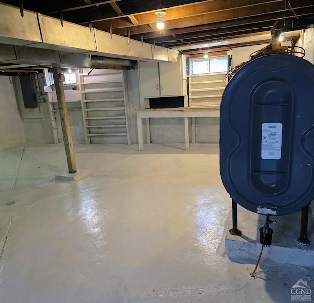 basement featuring electric panel and heating fuel