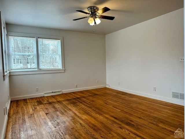 spare room with visible vents, baseboards, ceiling fan, and hardwood / wood-style floors