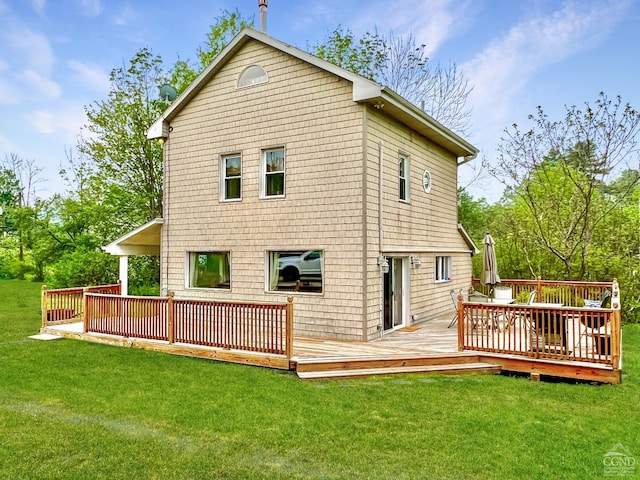 back of house with a lawn and a deck