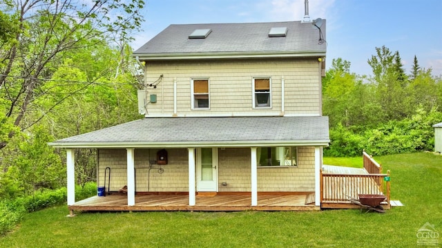 rear view of house featuring a lawn