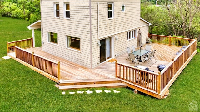 wooden terrace featuring a lawn