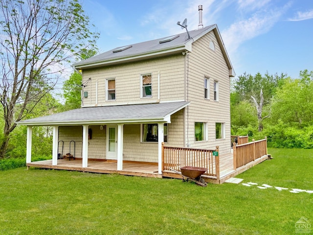 back of house with a yard and a deck