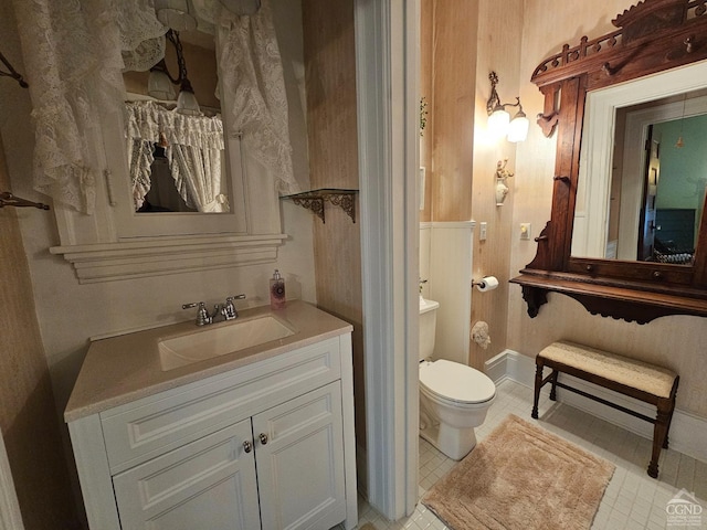 bathroom featuring tile patterned flooring, vanity, and toilet