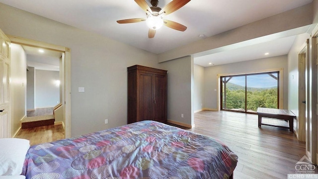 bedroom featuring light wood-type flooring, access to outside, and ceiling fan