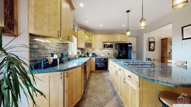 kitchen featuring a kitchen bar, light brown cabinets, backsplash, and black appliances