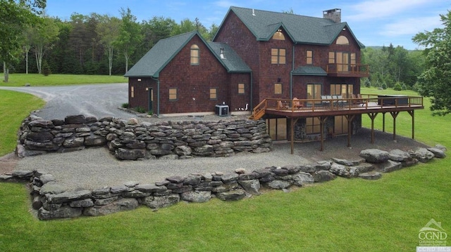 back of property featuring a yard, central AC unit, and a wooden deck