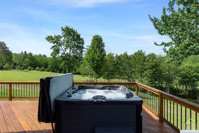 wooden deck featuring a yard and a hot tub