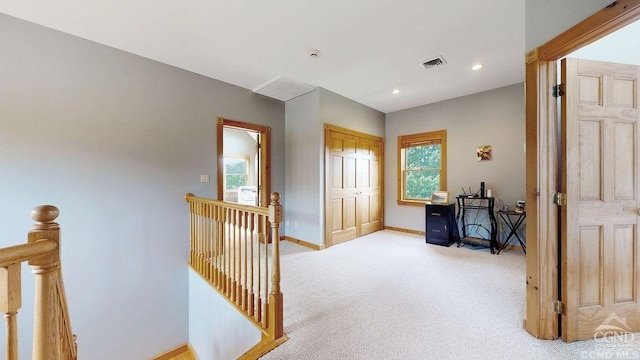 corridor featuring light colored carpet