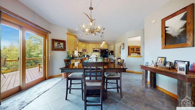 tiled dining room featuring a chandelier and sink