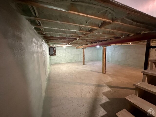 unfinished basement featuring electric panel