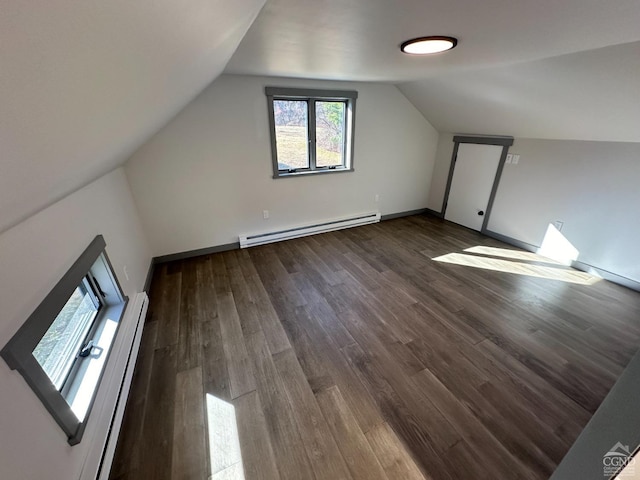 bonus room featuring a baseboard heating unit, vaulted ceiling, baseboard heating, and wood finished floors