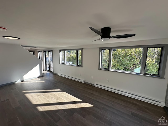 unfurnished living room with baseboard heating and wood finished floors