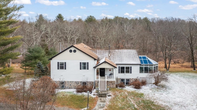 view of front of property featuring glass enclosure