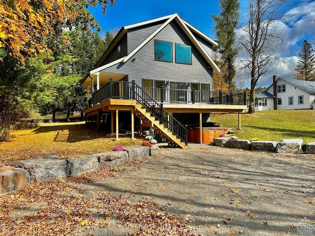 rear view of property featuring a deck and a yard