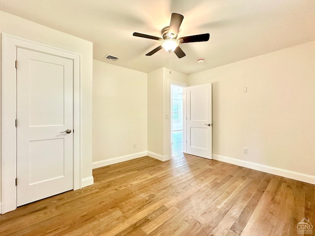 spare room with ceiling fan and light hardwood / wood-style flooring