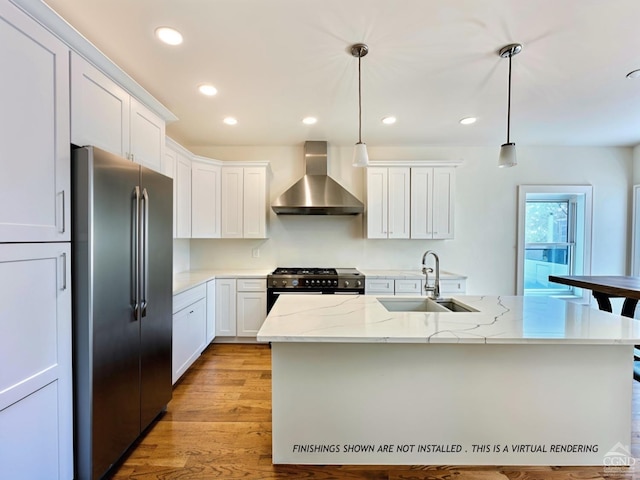 kitchen with sink, pendant lighting, wall chimney range hood, and high end appliances