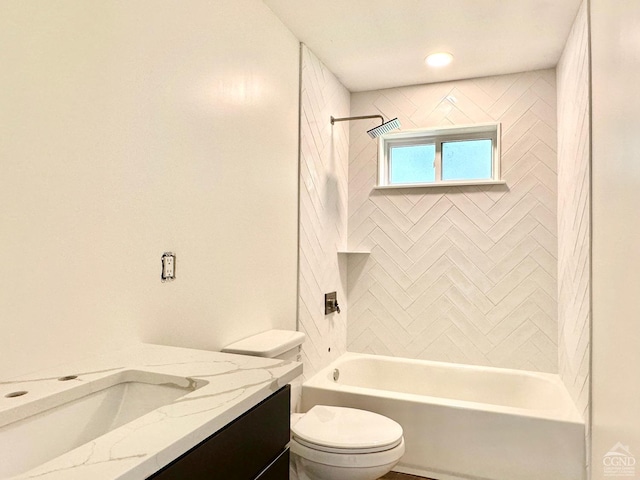 full bathroom with vanity, tiled shower / bath combo, and toilet