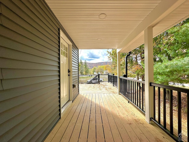 wooden terrace with a mountain view and a porch