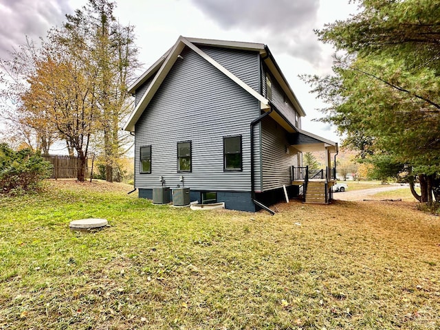 back of property with a yard and cooling unit