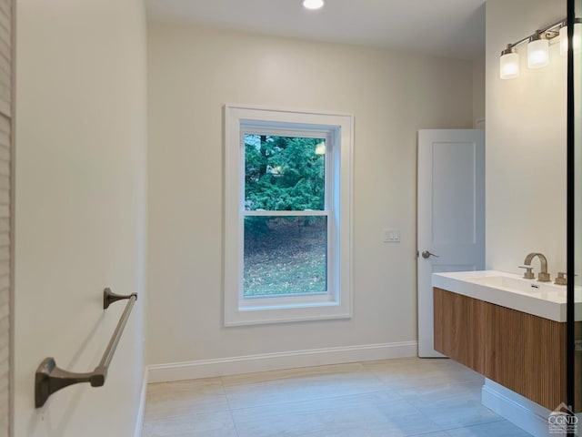 bathroom with tile patterned flooring, plenty of natural light, and vanity