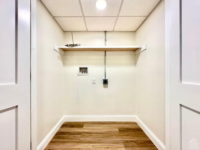 laundry area with electric dryer hookup, hookup for a washing machine, and hardwood / wood-style floors