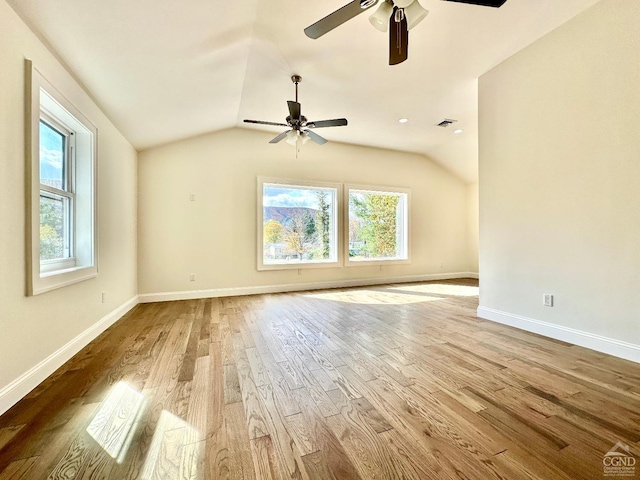 interior space with ceiling fan, light hardwood / wood-style floors, and vaulted ceiling