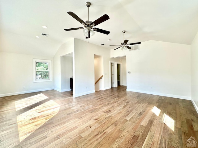 unfurnished living room featuring ceiling fan, light hardwood / wood-style floors, and lofted ceiling