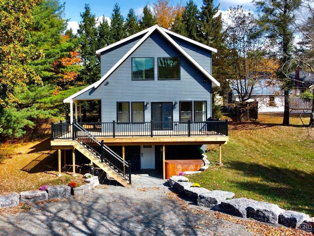 view of front of property featuring a front lawn and a deck