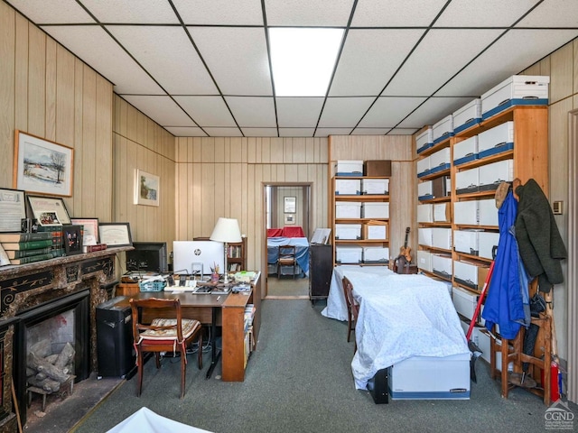 office area featuring a drop ceiling and wood walls