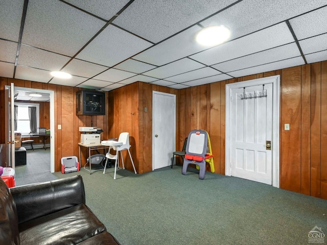 game room featuring a baseboard heating unit, carpet flooring, and wood walls