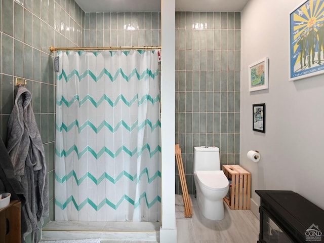 bathroom with walk in shower, tile patterned floors, toilet, tile walls, and radiator