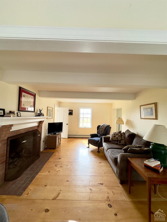 living room with a baseboard heating unit, a brick fireplace, beamed ceiling, and light wood finished floors