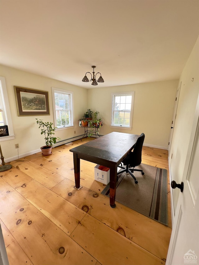 dining room with plenty of natural light, light wood-style flooring, and baseboards