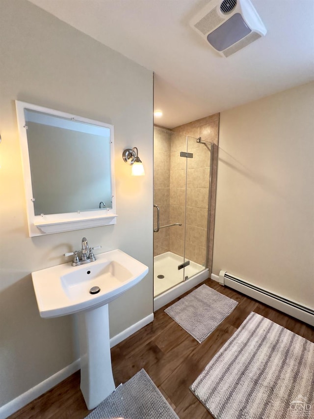 full bath featuring baseboards, wood finished floors, visible vents, and a stall shower