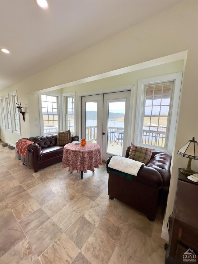 living area featuring recessed lighting, french doors, and a healthy amount of sunlight