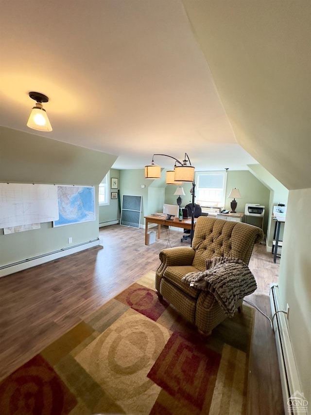 living room with a baseboard radiator, a healthy amount of sunlight, wood finished floors, and vaulted ceiling