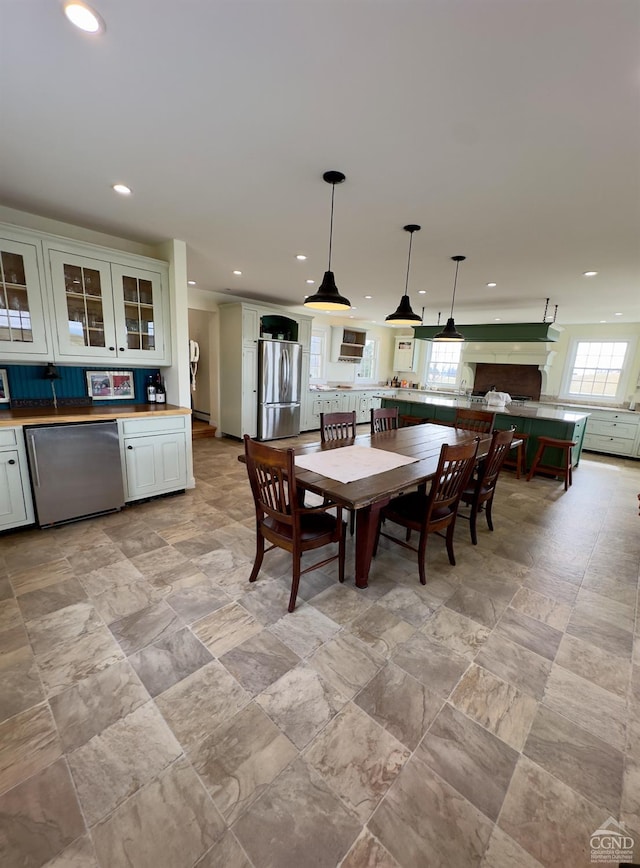 dining area featuring recessed lighting and bar area