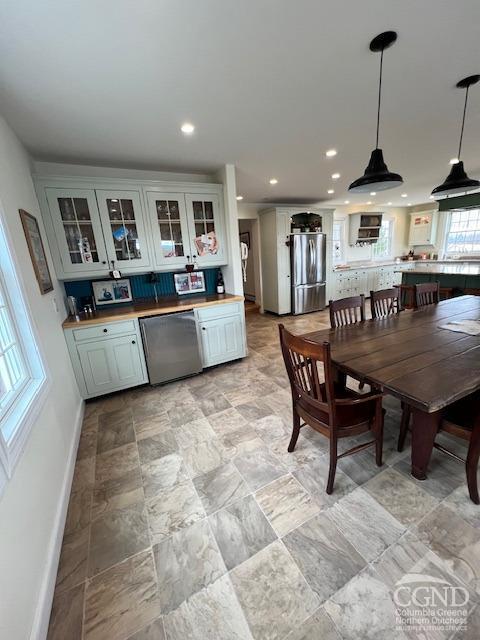 dining room featuring recessed lighting and baseboards