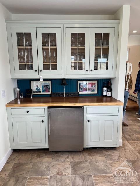 bar with fridge and baseboards