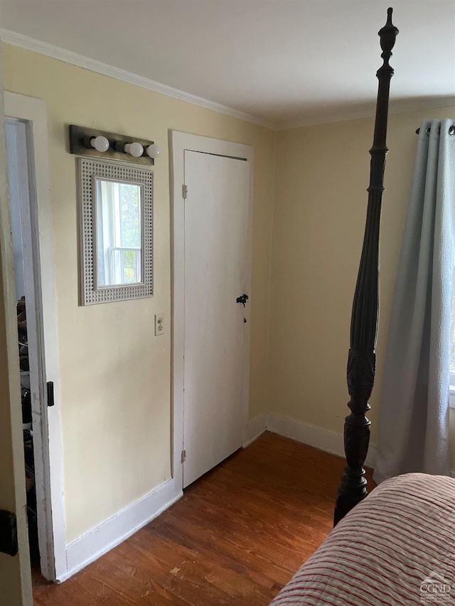 bedroom featuring hardwood / wood-style floors and ornamental molding