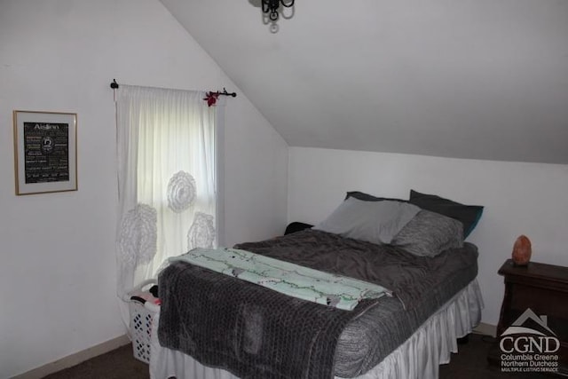 carpeted bedroom featuring lofted ceiling