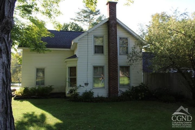 rear view of property featuring a yard