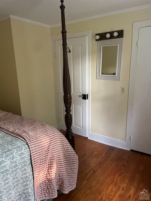 bedroom featuring dark hardwood / wood-style floors and ornamental molding