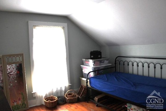 bedroom with wood-type flooring and lofted ceiling