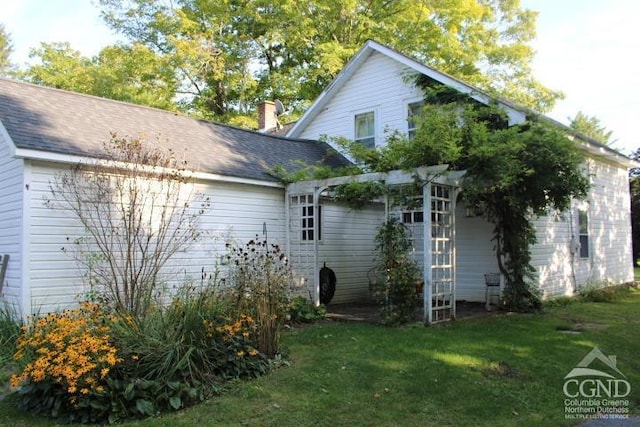 view of property exterior featuring a lawn